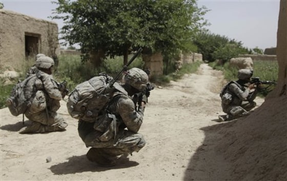 In this May 8 photo, U.S. Army soldiers with 2nd Platoon, Alpha Company, 2nd Battalion, 1st Infantry Regiment of the 5th Stryker Brigade, keep their eyes in the direction of two fleeing Taliban fighters, in Afghanistan's Kandahar province.